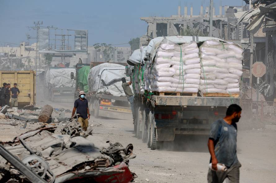 Trucks carry aid for Palestinians in Khan Younis