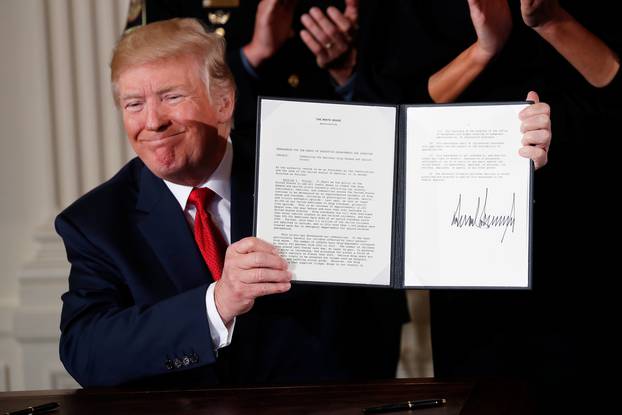 U.S. President Donald Trump displays a presidential public health emergency declaration on the nation