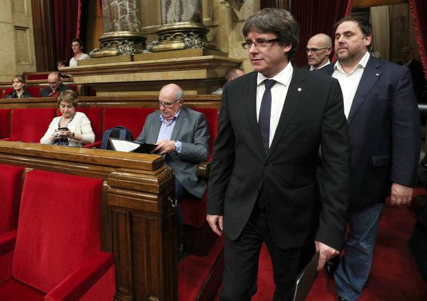 Catalan President Carles Puigdemont arrives in the chamber at the Catalonian regional parliament in Barcelona