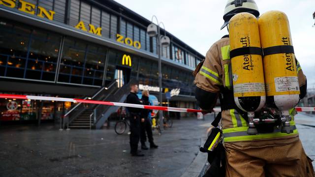 A firefighter stands outside the Berlin's Zoo train station after a large amount of smoke was detected and several people were rescued from the scene in Berlin