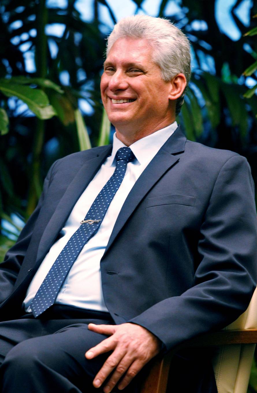 Cuban President Miguel Diaz-Canel reacts as he speaks to Venezuela's President Nicolas Maduro (not pictured) at the Revolution Palace in Havana
