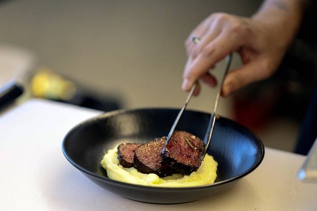 A chef arranges a dish containing 3D printed plant-based vegan meat, produced by Israeli start-up Redefine Meat in Rehovot, Israel