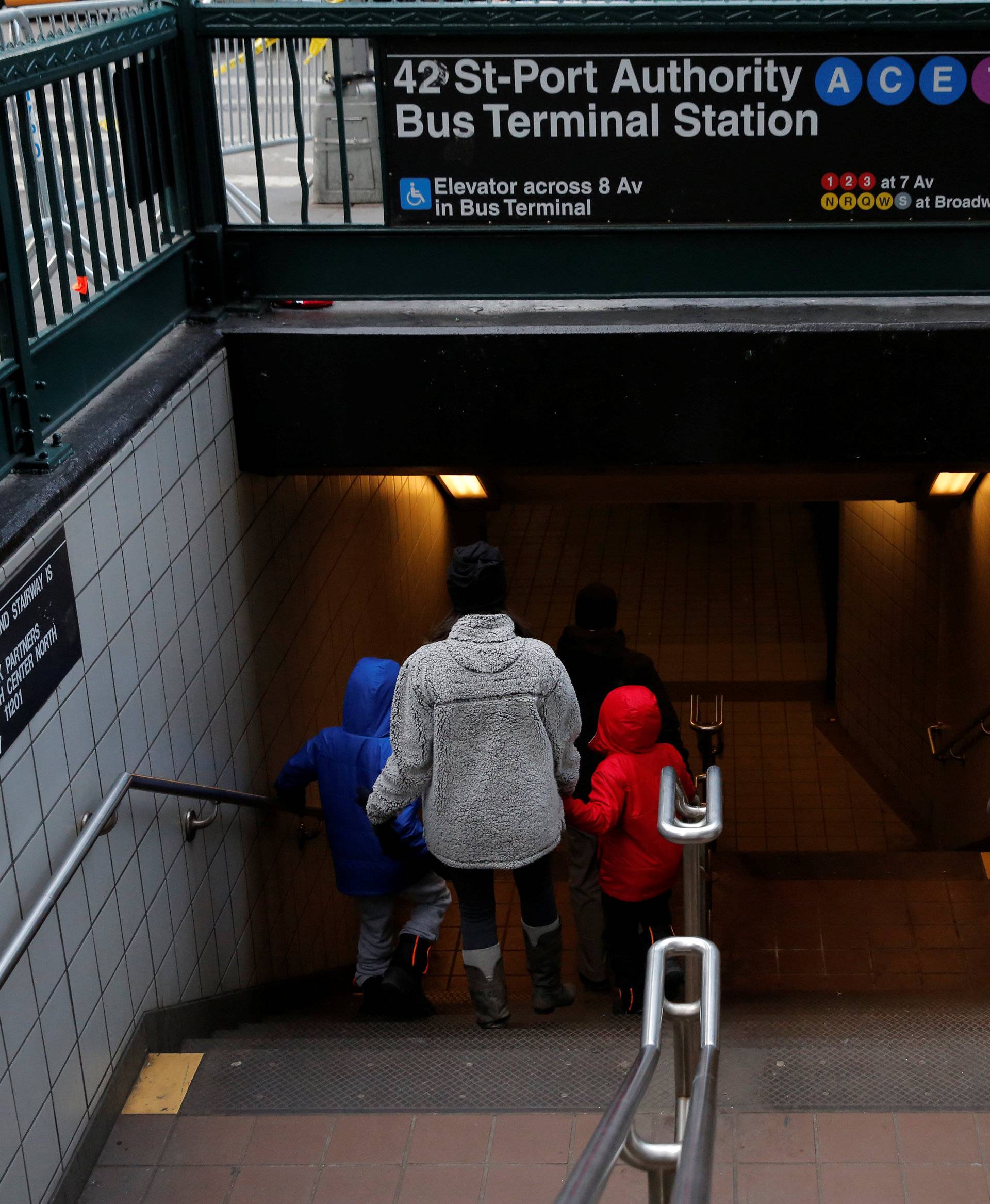 People enter the subway station by the New York Port Authority Bus Terminal following an attempted detonation during the morning rush hour, in New York City