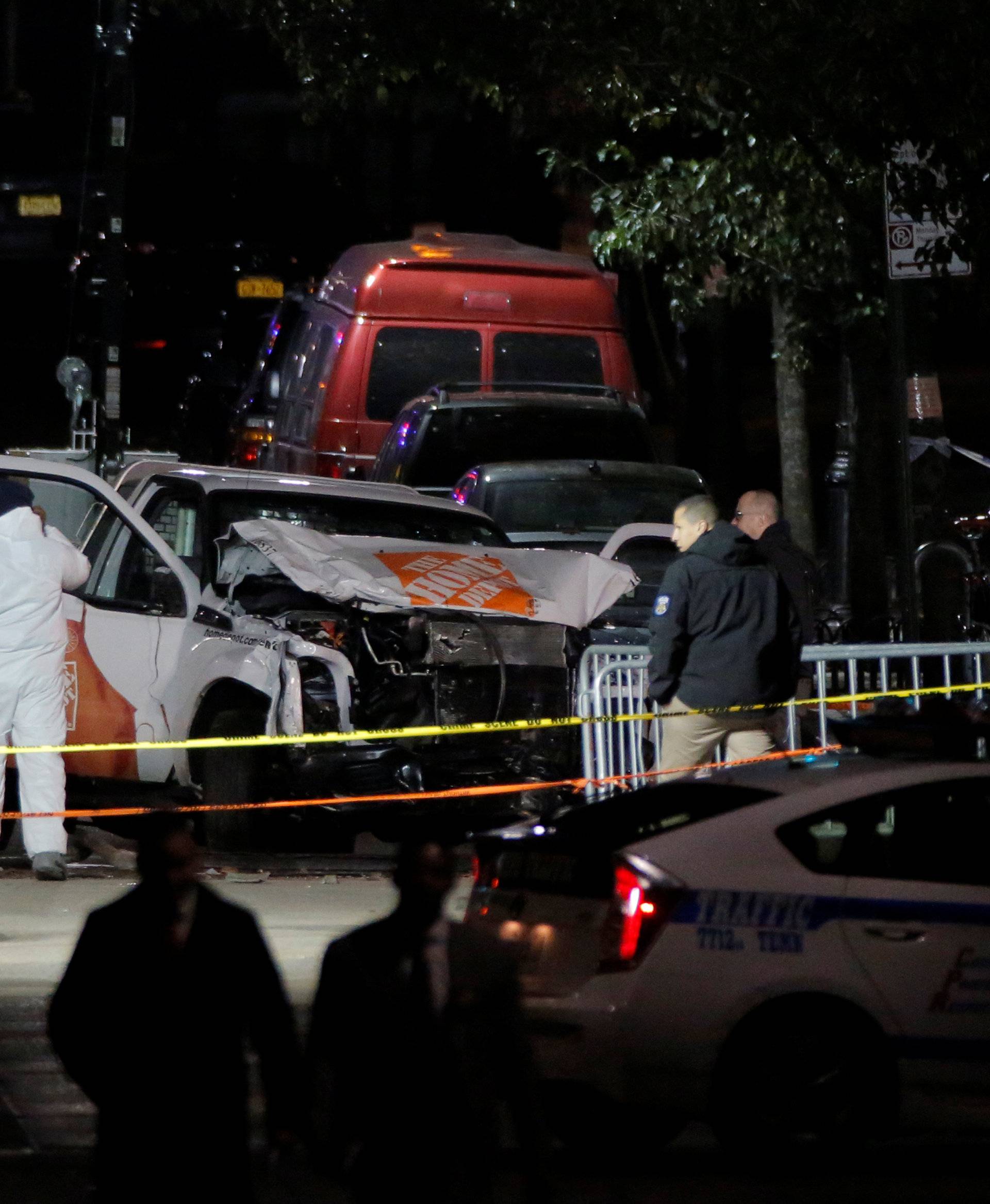 Police investigate a pickup truck used in an attack on the West Side Highway in Manhattan