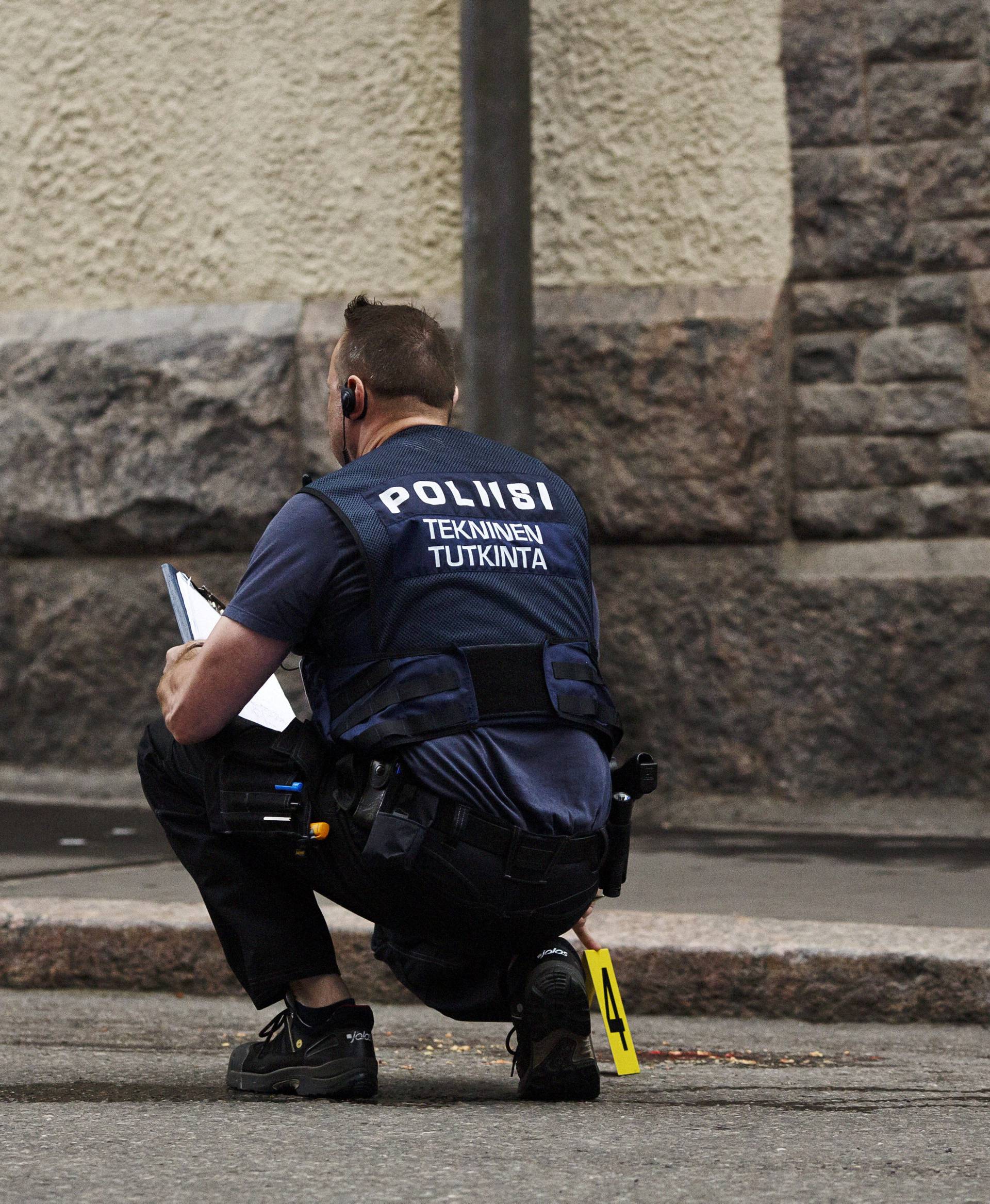 A police officer is seen at the scene of an accident in downtown Helsinki where an intoxicated man hit people with his car