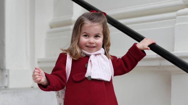 Britain's Princess Charlotte stands on the steps at Kensington Palace in a photograph taken taken by her mother and handed out by Britain's Prince William and Catherine, the Duchess of Cambridge