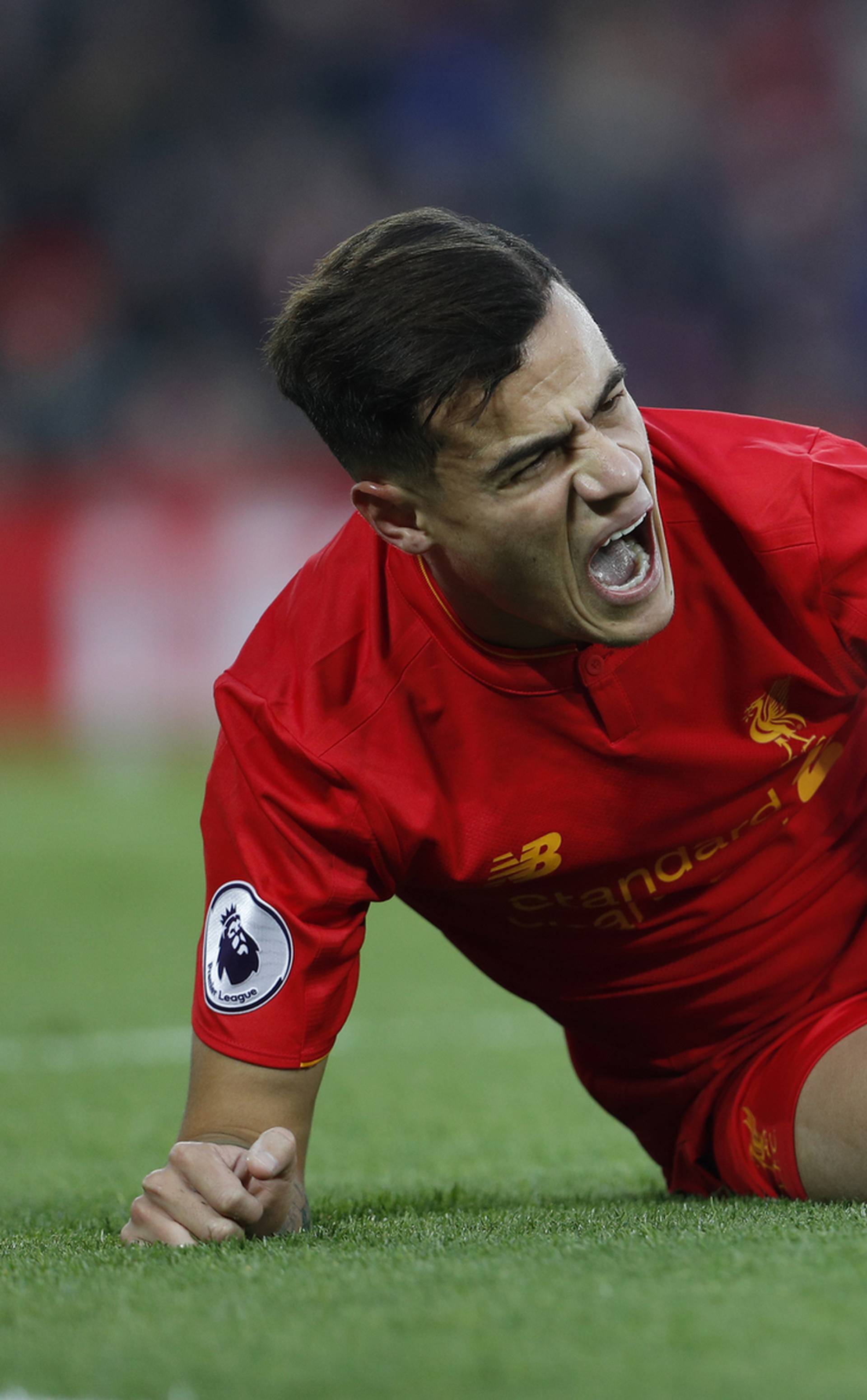 Liverpool's Philippe Coutinho reacts after sustaining an injury