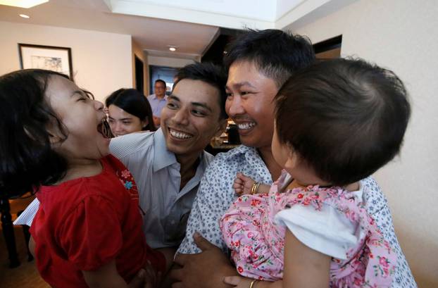 Reuters reporters Wa Lone and Kyaw Soe Oo celebrate with their children after being freed from prison, after receiving a presidential pardon in Yangon