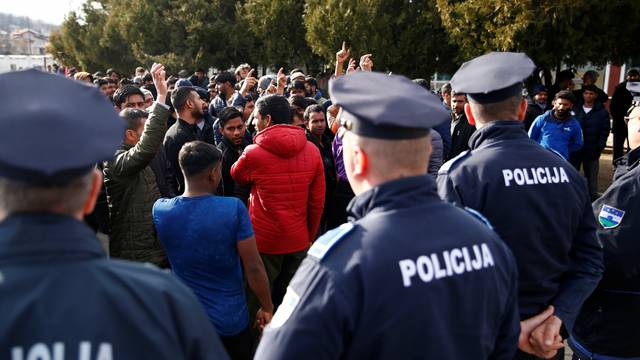 Migrants are stoped by police while trying to block road in front of the refugee camp Miral in Velika Kladusa