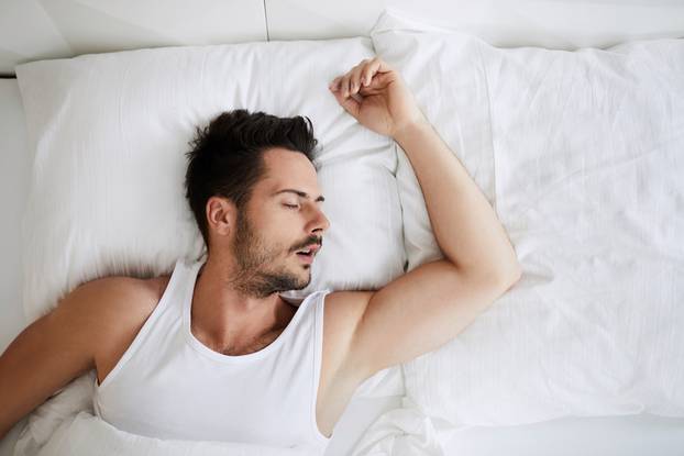 Top,View,Of,Young,Attractive,Man,Sleeping,With,Mouth,Open