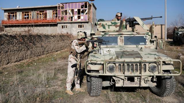 Afghan security forces take position at the site of an attack in a U.S. military air base in Bagram