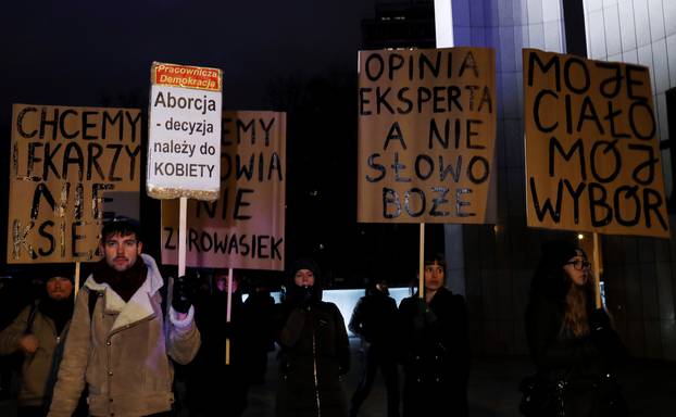 People gather to protest against plans to further restrict abortion laws in front of the Parliament in Warsaw