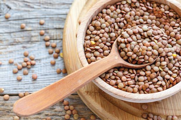 Lentils,And,Spoon,In,A,Wooden,Bowl,Close,Up,On