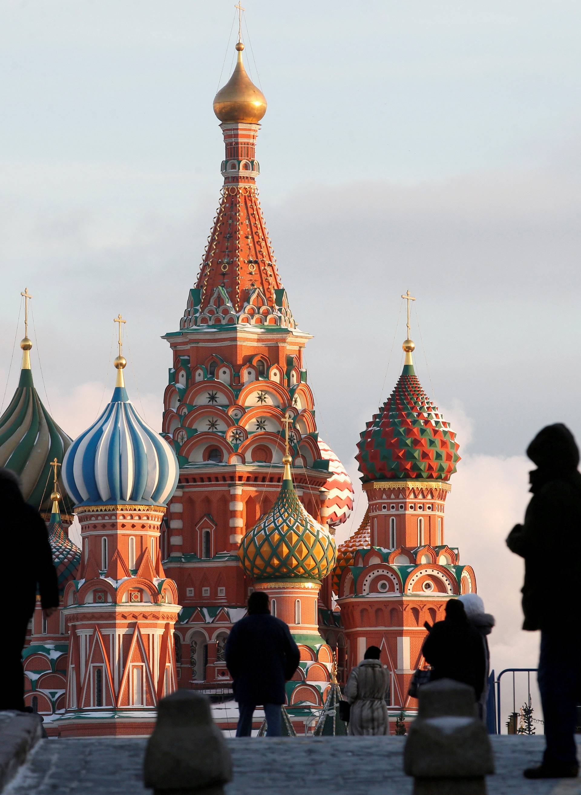 FILE PHOTO:  People walk in Red Square, with St. Basil's Cathedral seen in the background, in Moscow