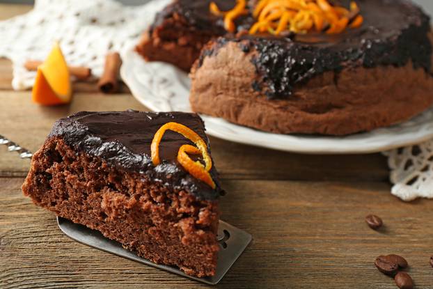 Cake,With,Chocolate,Glaze,And,Orange,On,Wooden,Background