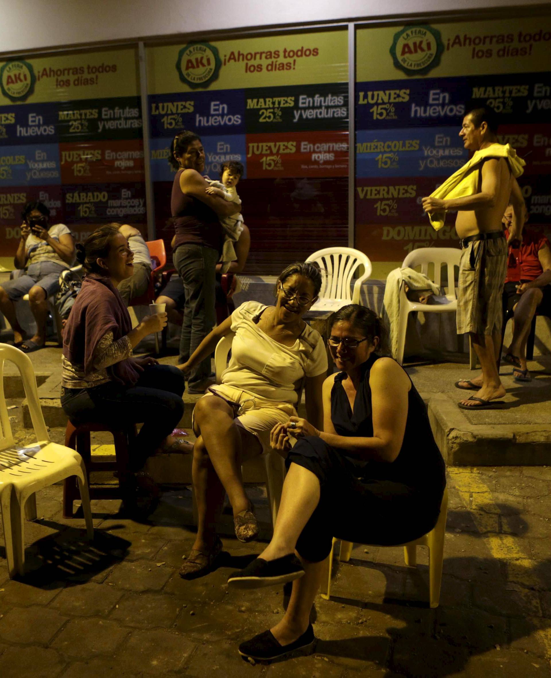 Residents rest on a sidewalk in Portoviejo after an earthquake struck Ecuador
