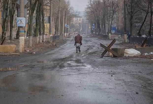 A local resident walks at empty street in Bakhmut