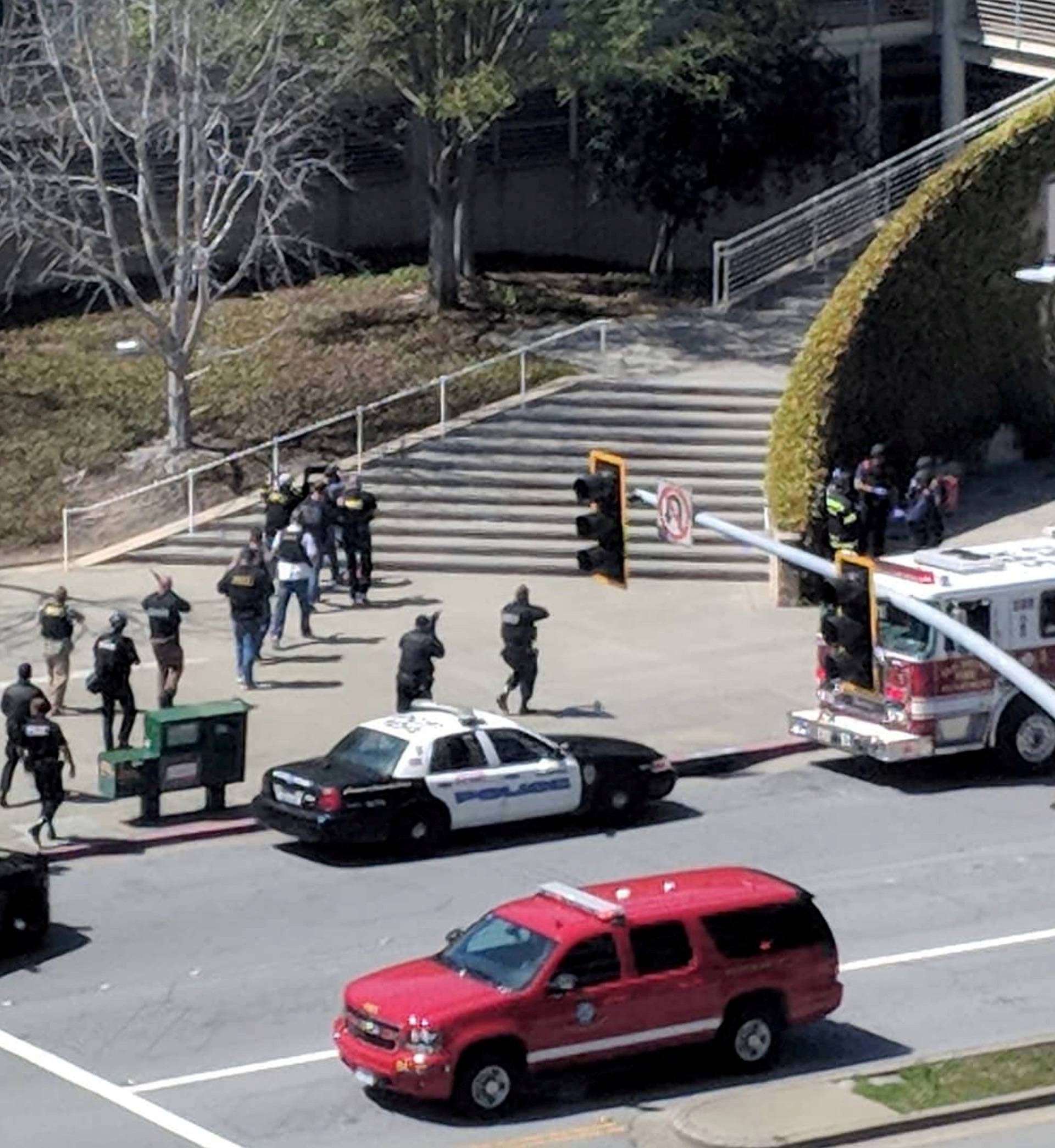 Law enforcement officials react following a possible shooting at the headquarters of YouTube in San Bruno, California