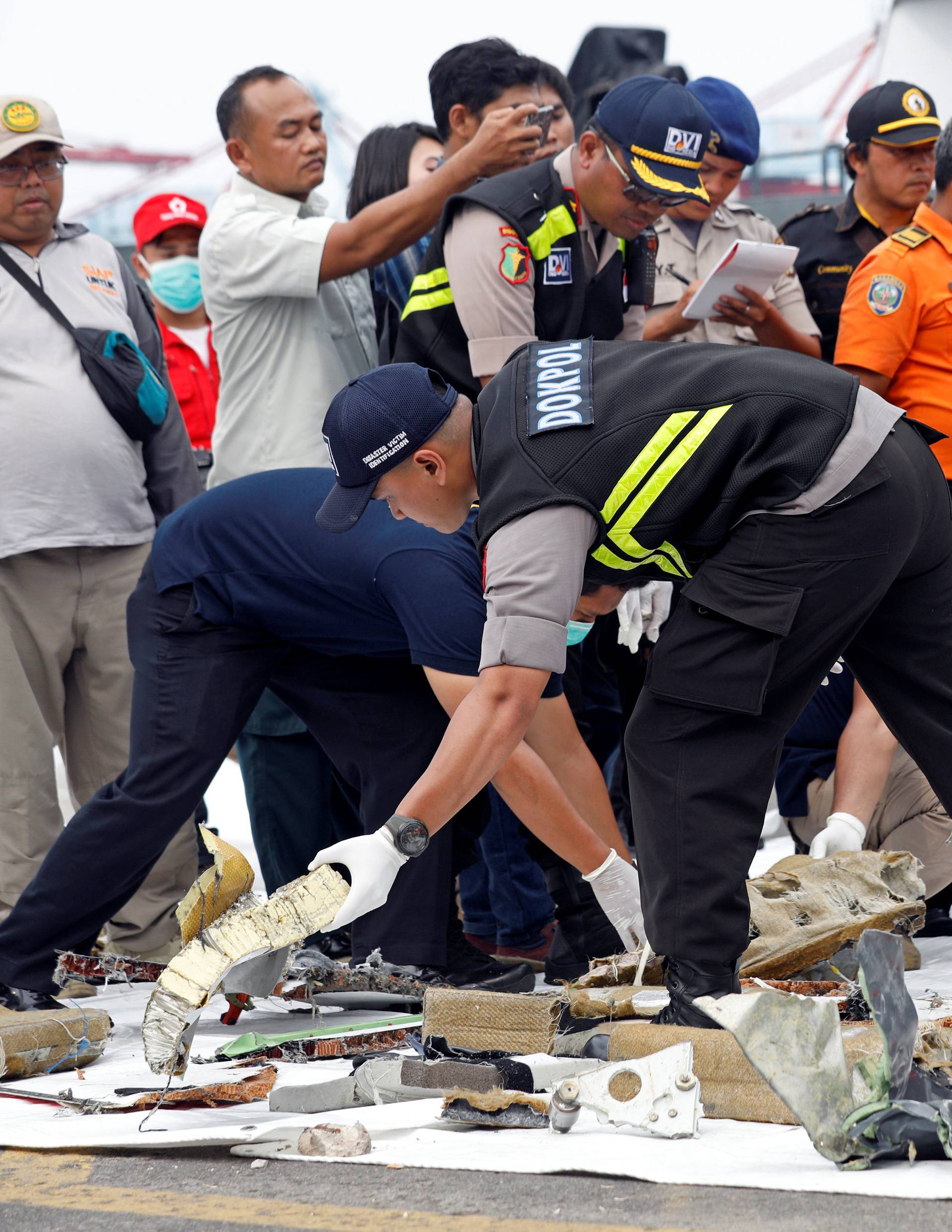 Rescue workers lay out newly recovered debris of Lion Air flight JT610 at Tanjung Priok port in Jakarta