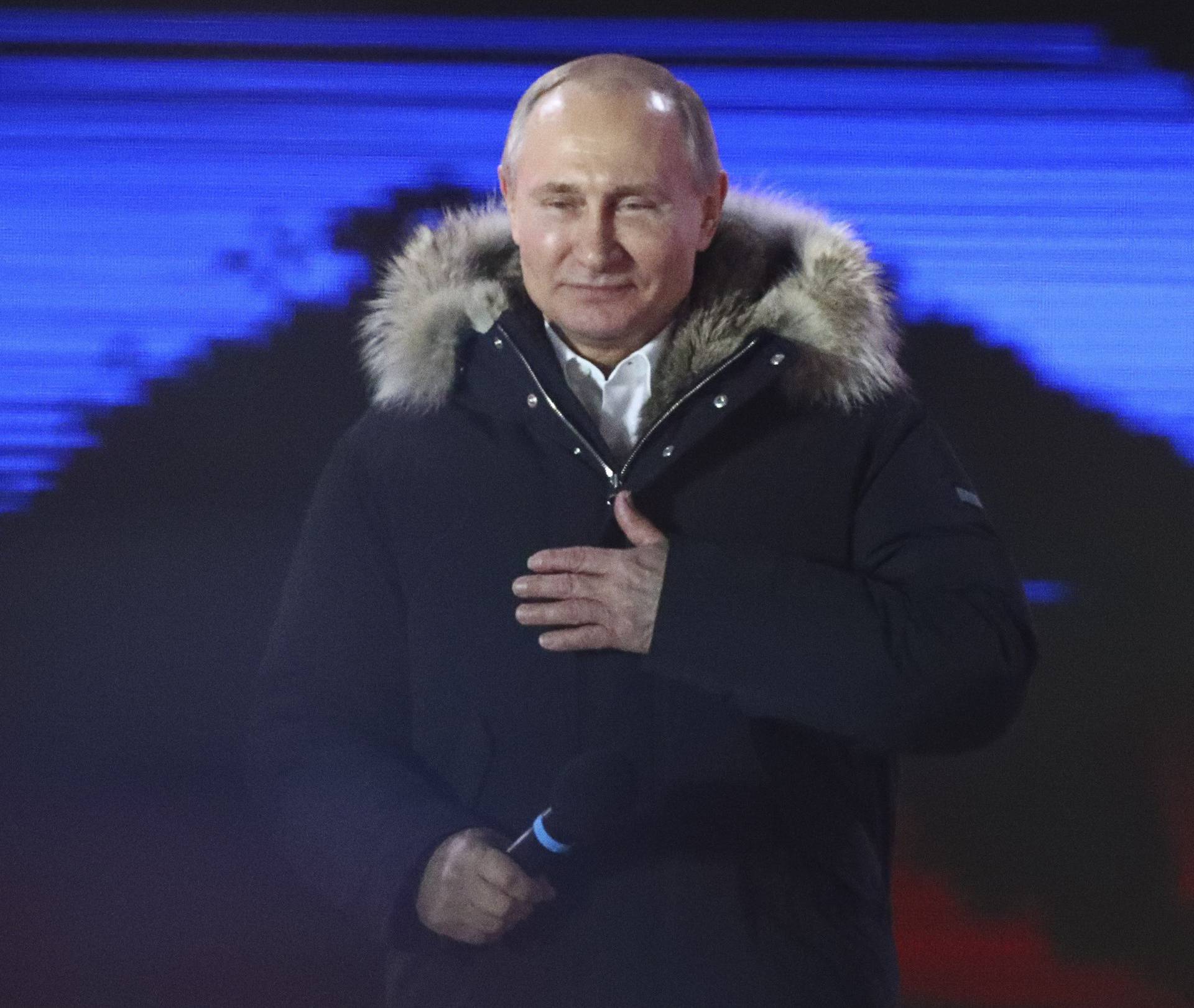 Russian President and Presidential candidate Putin attends a rally and concert marking the fourth anniversary of Russia's annexation of the Crimea region, in Moscow