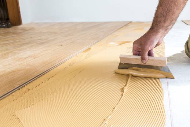 Laying,Hardwood,Parquet.,Putting,Glue,On,The,Floor.