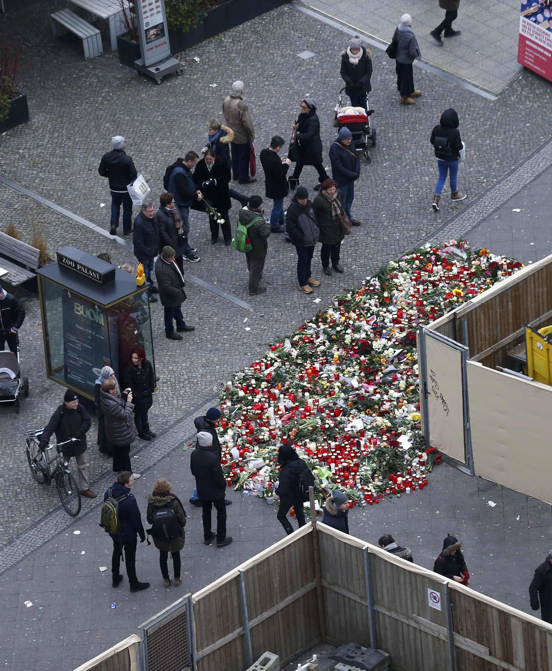 Flowers and candles are placed near the Christmas market in Berlin