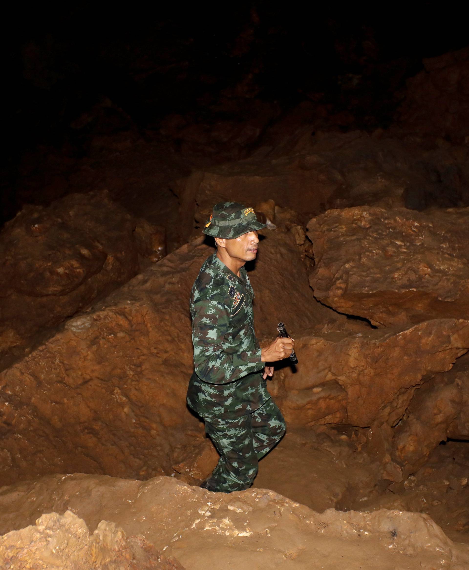 A military personnel is seen inside of the Tham Luang caves where 13 members of an under-16 soccer team were trapped in the northern province of Chiang Rai