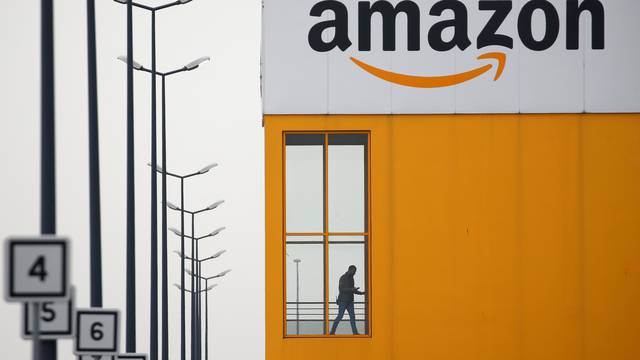 FILE PHOTO: The logo of Amazon is seen at the company logistics center in Lauwin-Planque