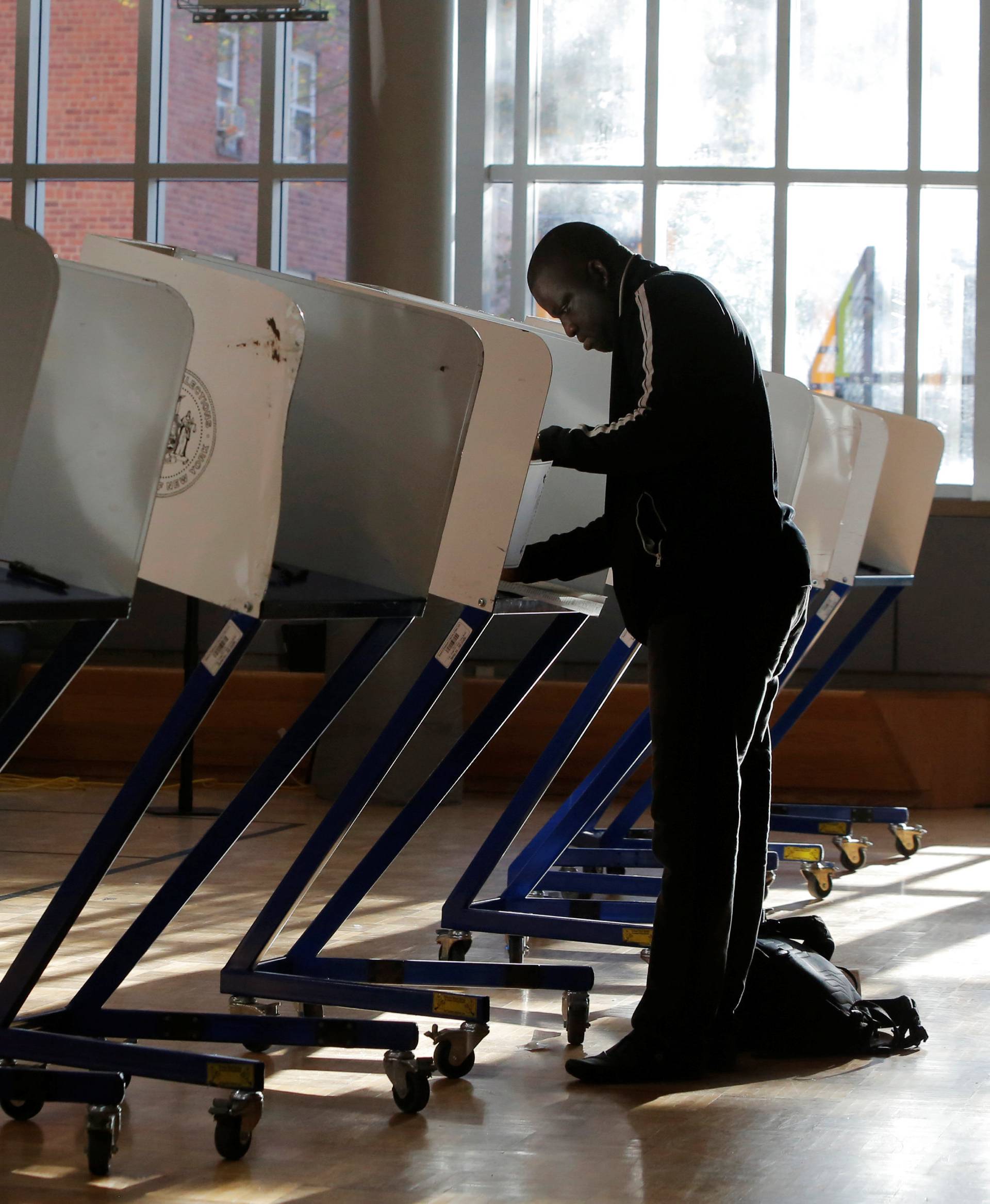 A man fills out a ballot for the U.S presidential election at the James Weldon Johnson Community Centre in the East Harlem neighbourhood of Manhattan, New York