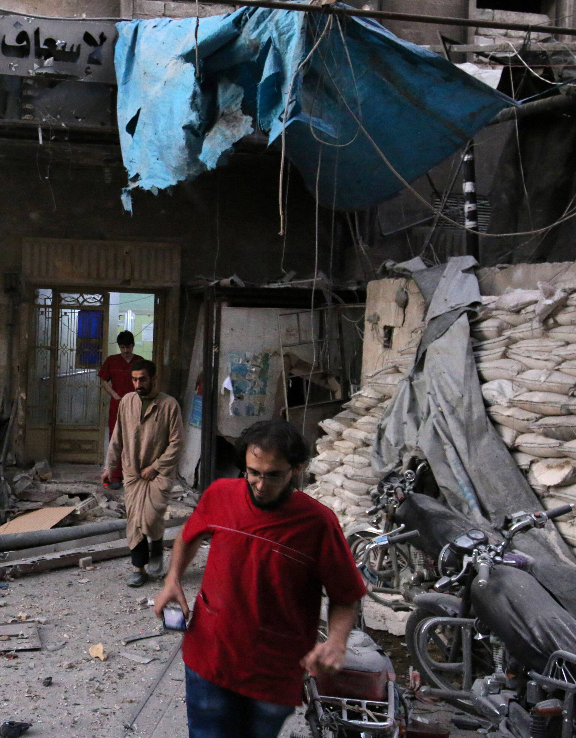 Medics inspect the damage outside a field hospital after an airstrike in the rebel-held al-Maadi neighbourhood of Aleppo