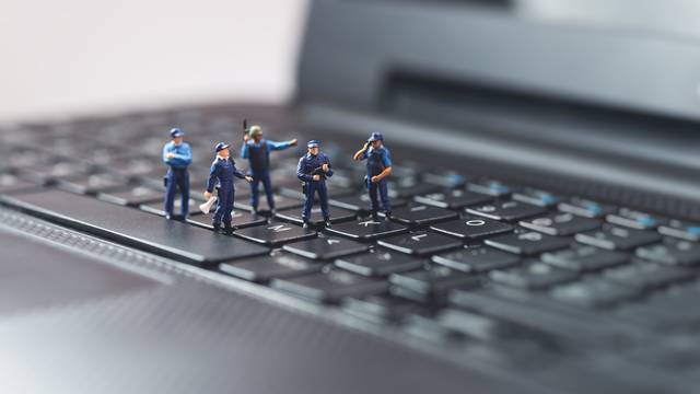 Miniature,Police,Squad,Protecting,Laptop,Computer.,Technology,Concept