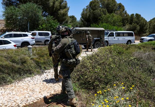 Israeli emergency services work at the scene of what Israeli police say was a series of shooting attacks in central Israel