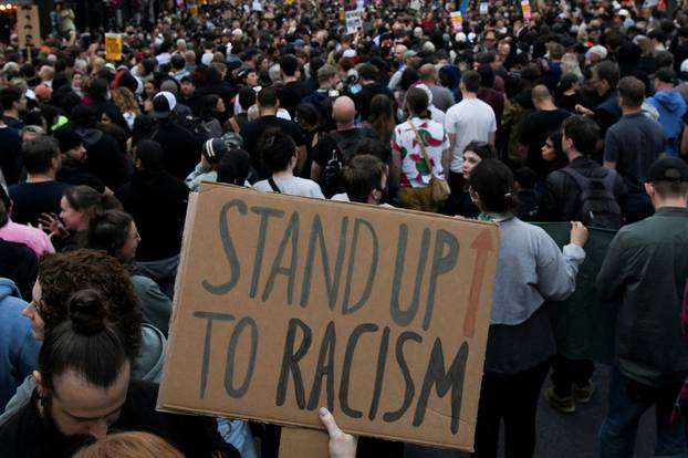 People gather against an an anti-immigration protest, in London