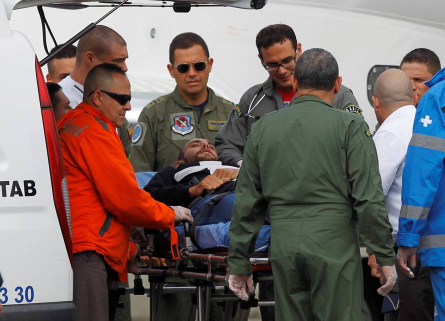 Alan Ruschel, player of Brazilian soccer team Chapecoense, lies on a stretcher before being loaded into a plane of Brazilian's Air Force for his return to Brazil, in Rionegro