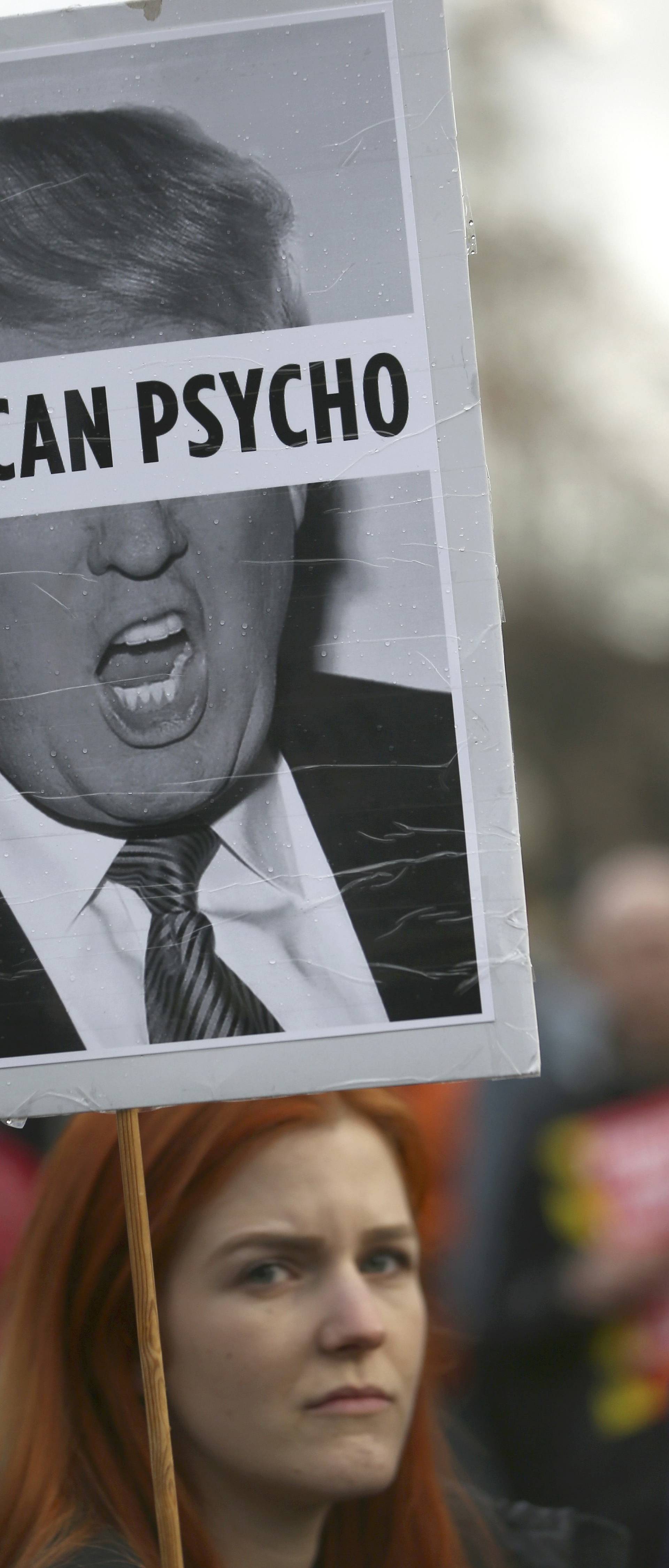 A demonstrator holds a placard during a march against U.S. President Donald Trump in London