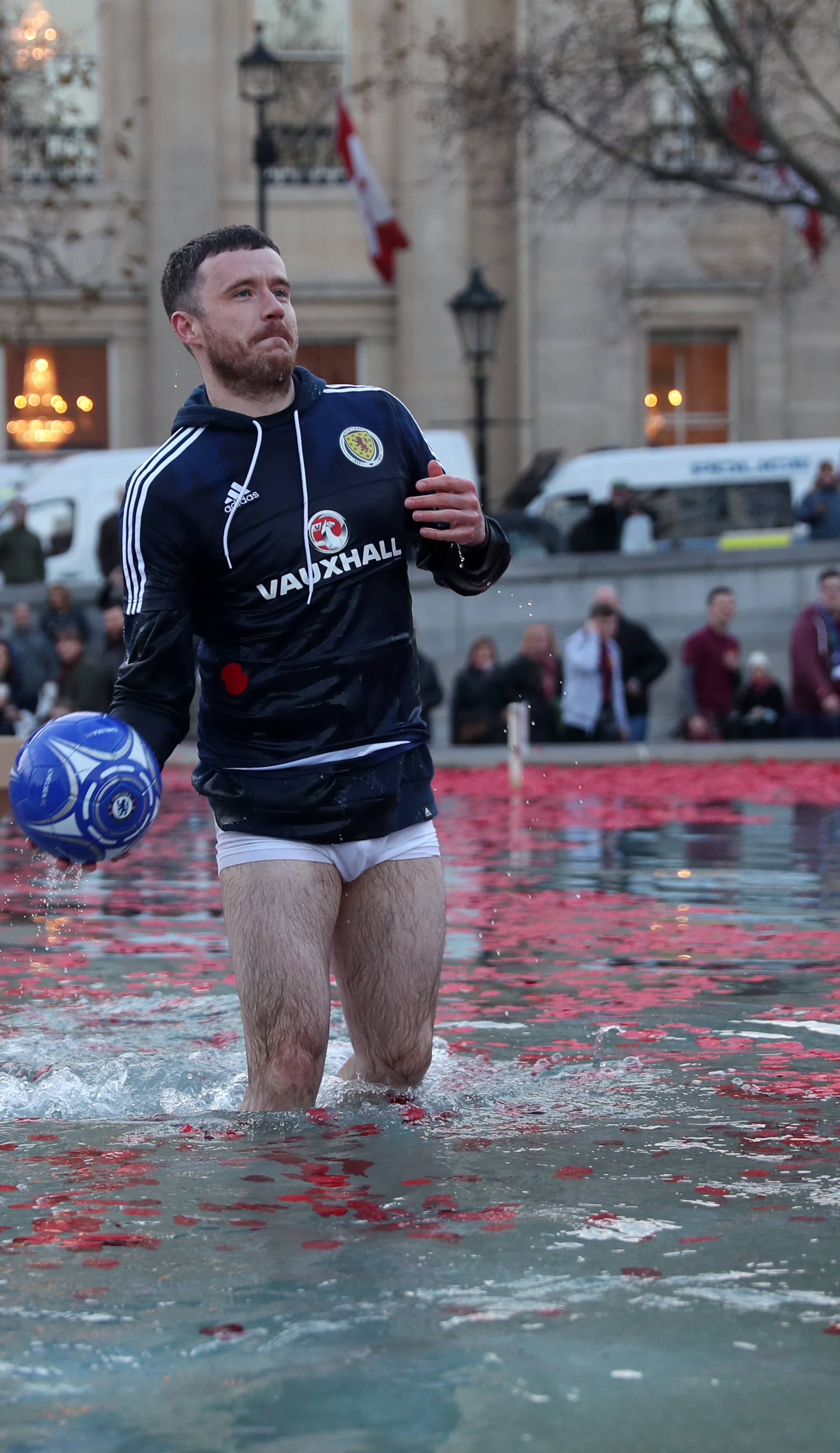 A Scotland fan in the water fountain in Trafalgar Square