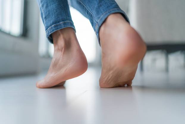 Floor,Heating,Woman,Walking,Barefoot,On,Hardwood,Floor,In,Winter