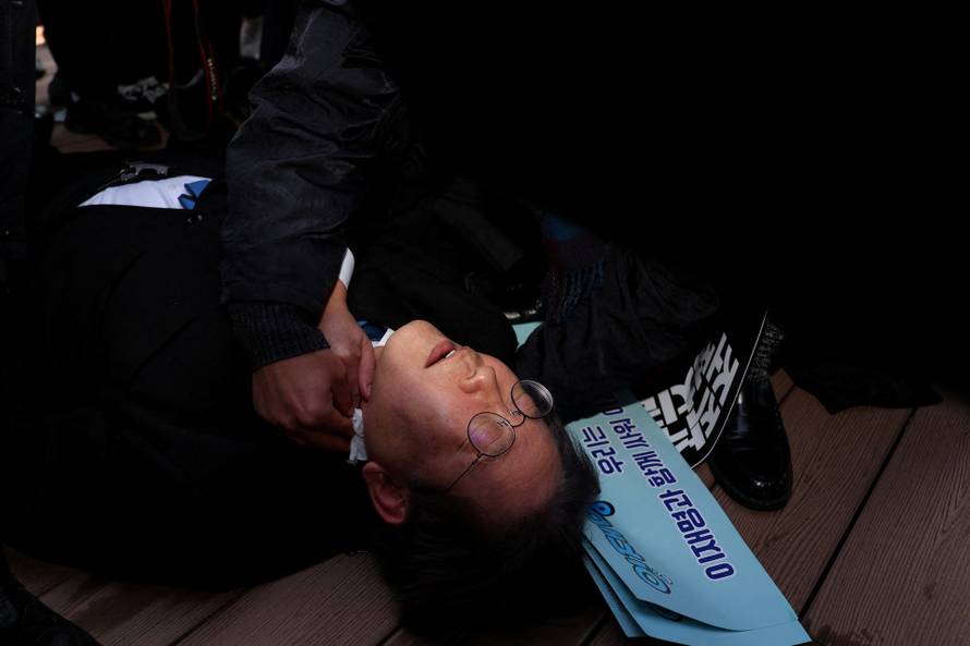 South Korea's opposition party leader Lee Jae-myung falls after being attacked by an unidentified man during his visit to Busan