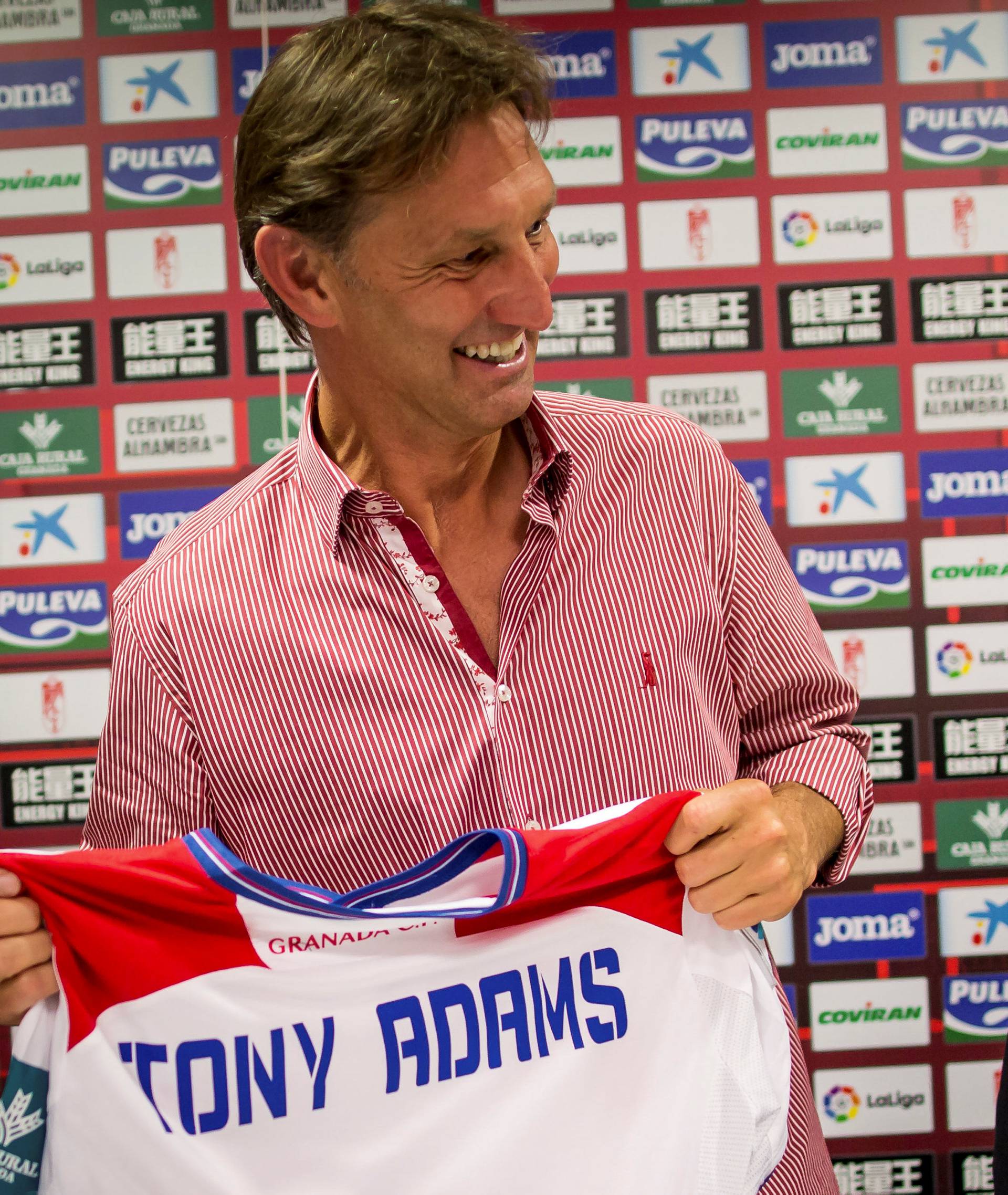 Former Arsenal and England captain Adams holds Granada's jersey next to club's VP Wang after being presented as new head coach in Granada