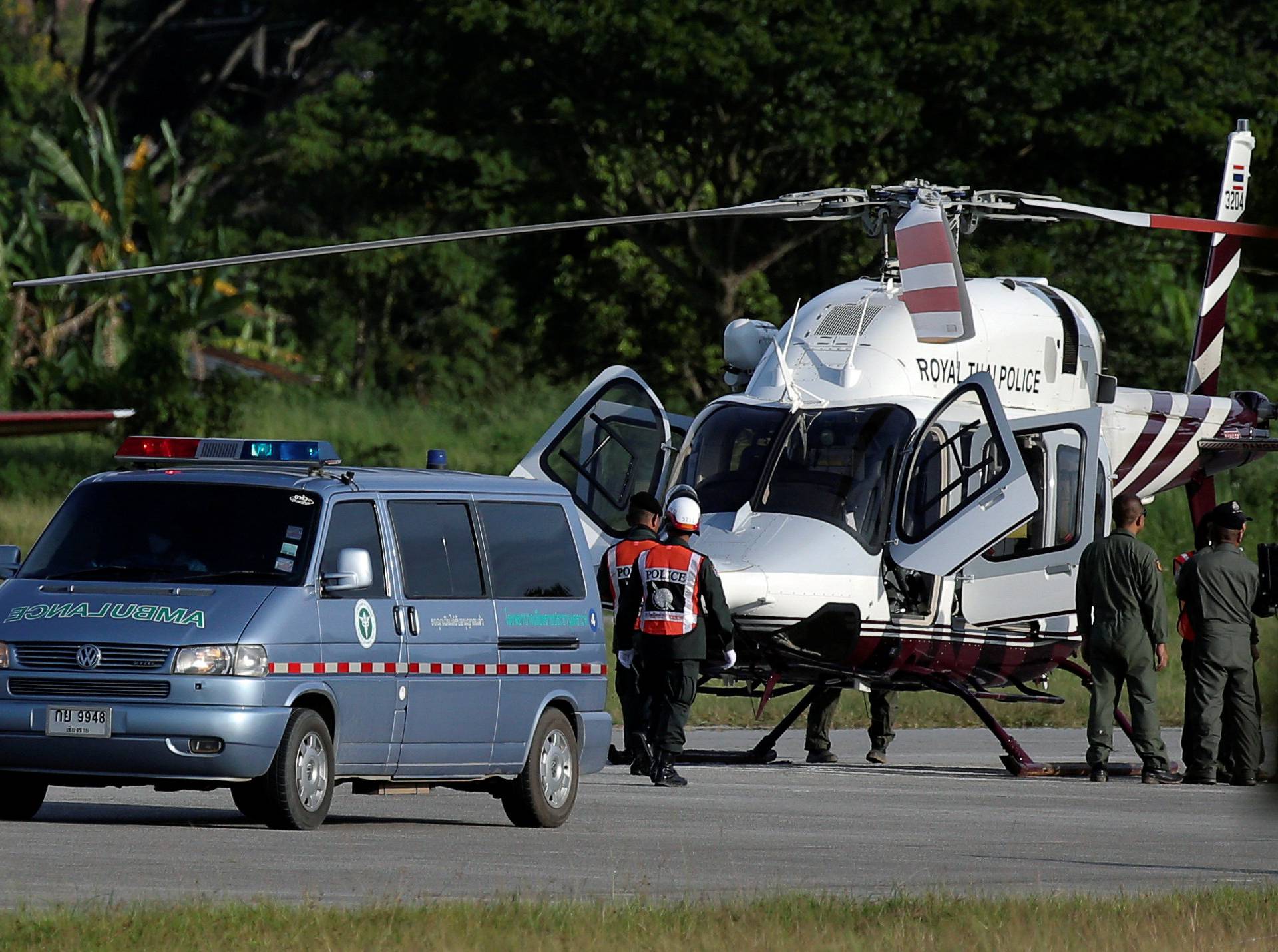 An ambulance carrying rescued schoolboys travels to a hospital from a military airport in Chiang Rai
