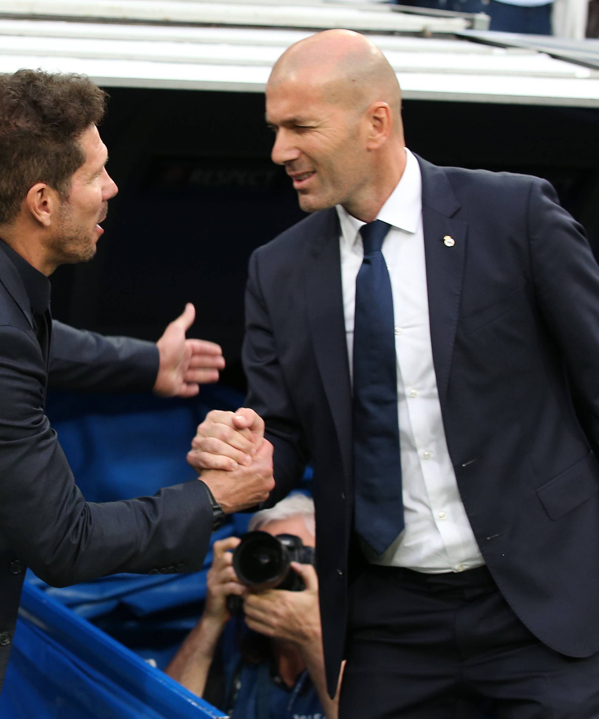 Real Madrid coach Zinedine Zidane greets Atletico Madrid coach Diego Simeone before the match
