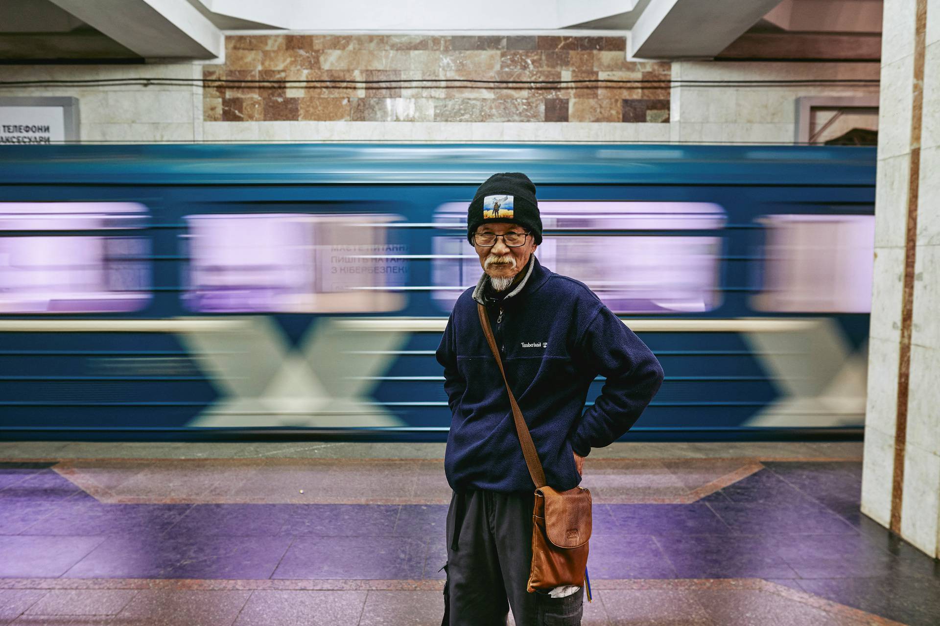 Humanitarian volunteer  Fuminori Tsuchiko from Japan poses for a picture at a platform of a subway station where he spent few months with locals amid Russia's attack in Kharkiv