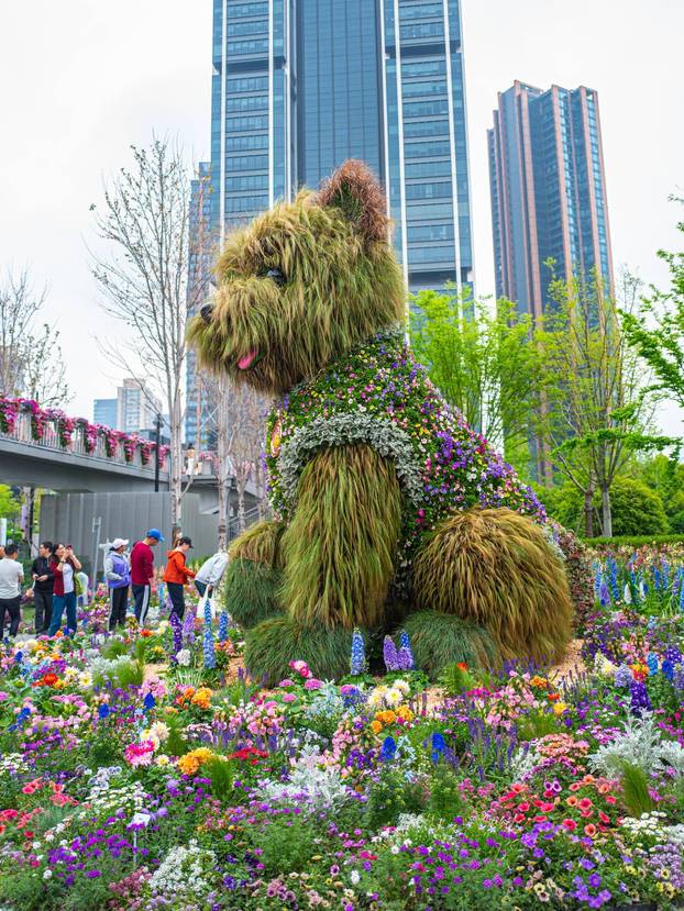 SHANGHAI, CHINA - APRIL 19: A 5.2-meter-tall puppy made of flowers and greenery steals the spotlight at the ongoing 2026