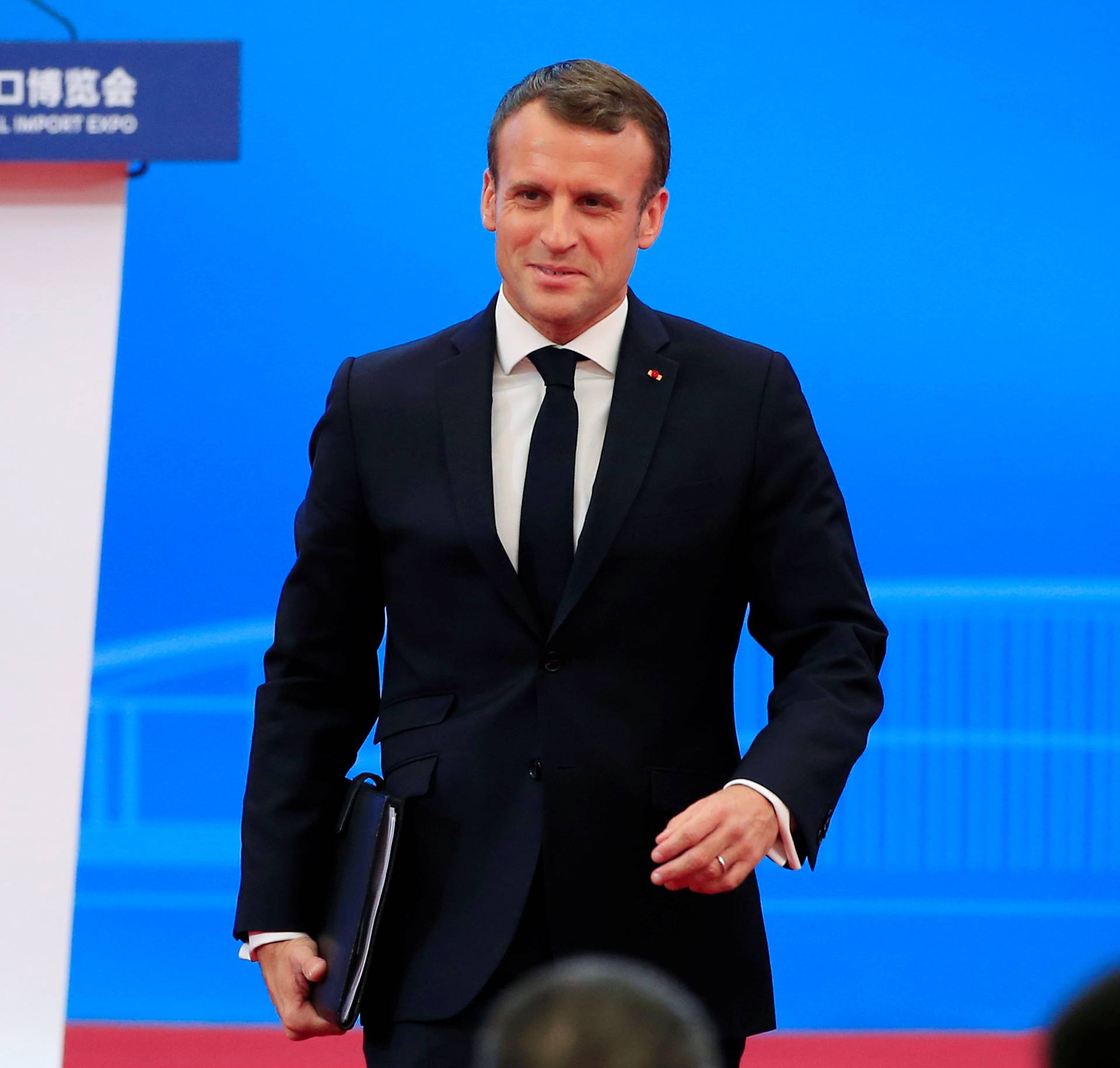 French President Emmanuel Macron returns to his seat following his speech at the opening ceremony of the second China International Import Expo (CIIE) in Shanghai