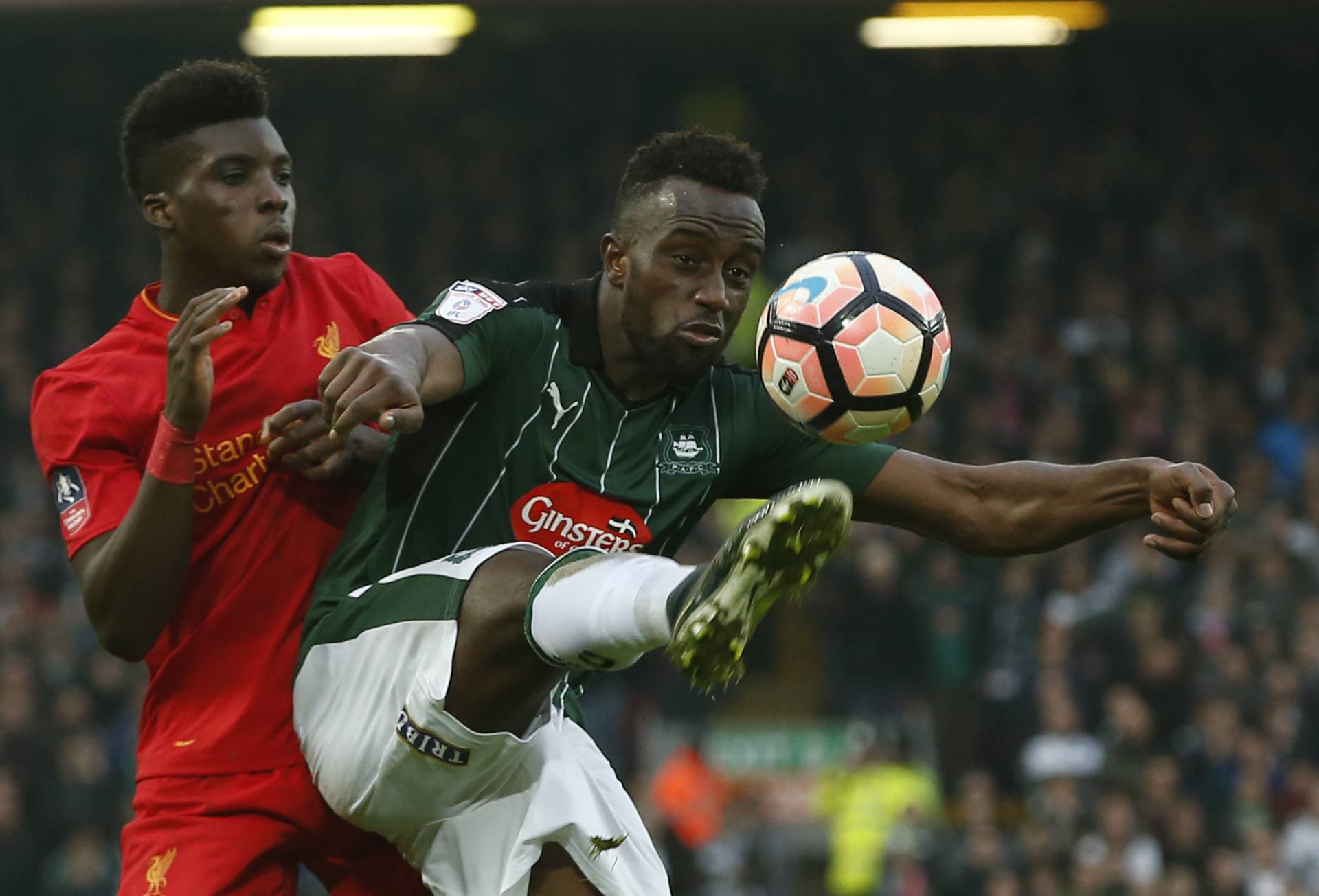 Plymouth Argyle's Jordan Slew in action with Liverpool's Sheyi Ojo