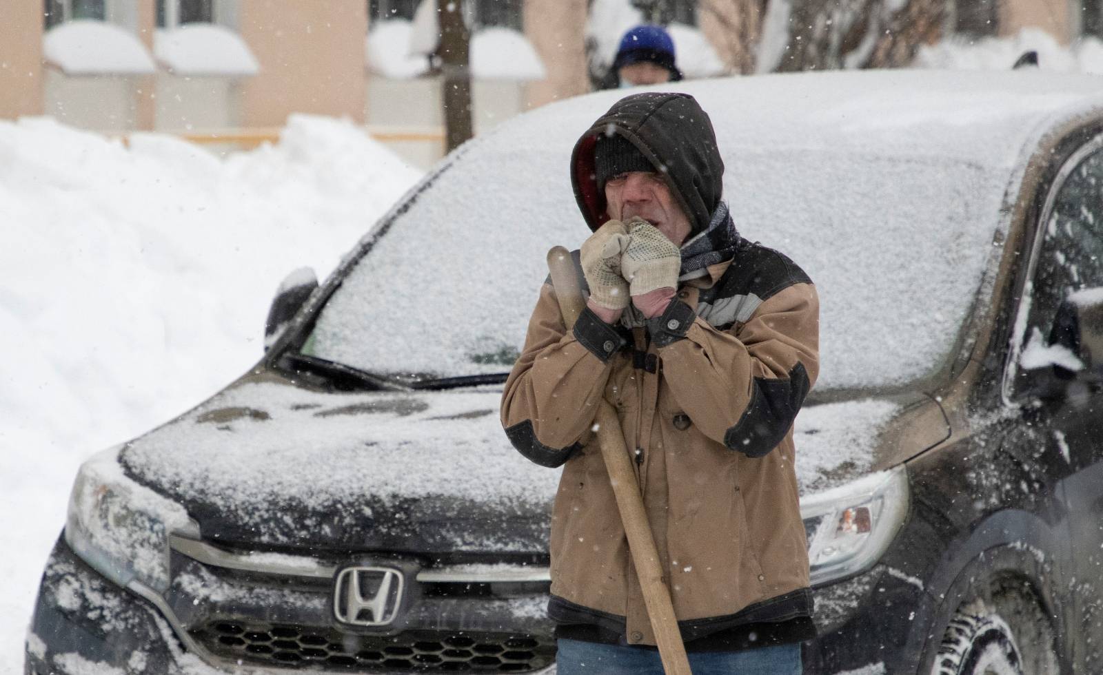 A worker removes snow in a street in Moscow