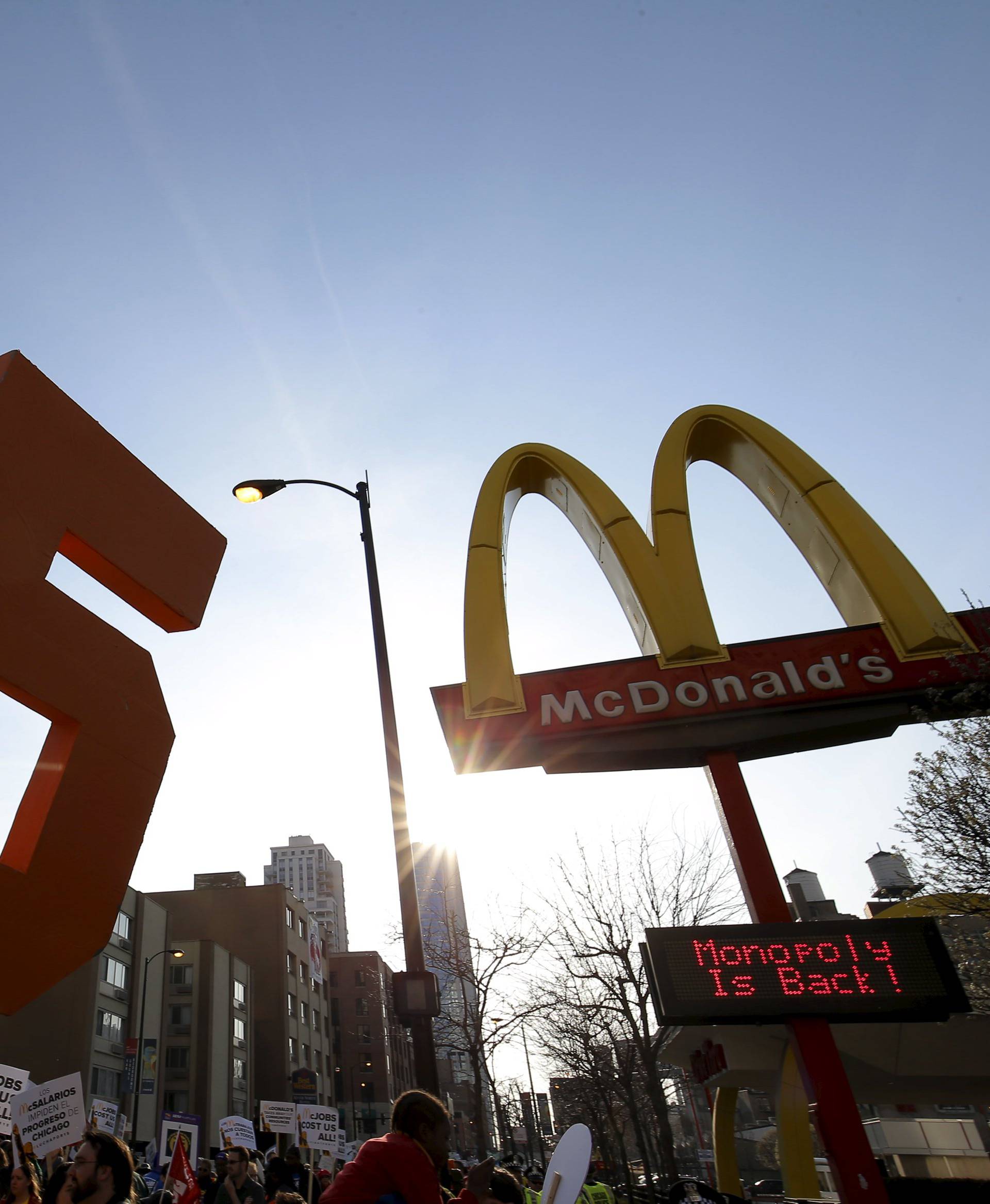 Demonstrators march past a McDonald's restaurant during a protest calling for a $15-an-hour nationwide minimum wage in downtown Chicago
