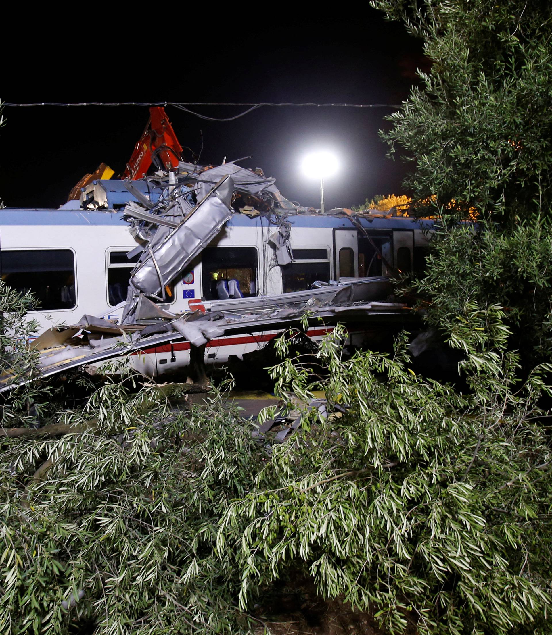 Trees frame the site where two passenger trains collided in the middle of an olive grove in the southern village of Corato