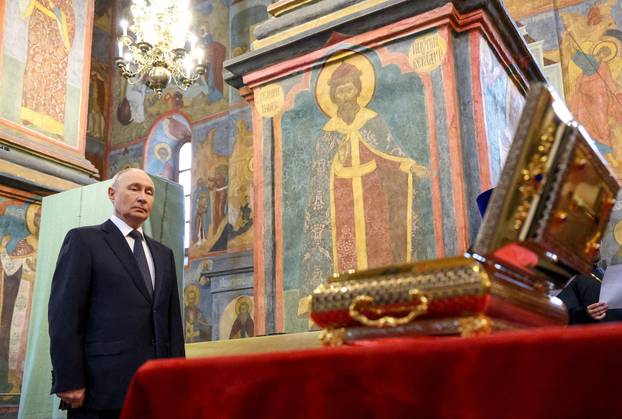 FILE PHOTO: Russian President Vladimir Putin visits the Archangel Cathedral of the Kremlin in Moscow