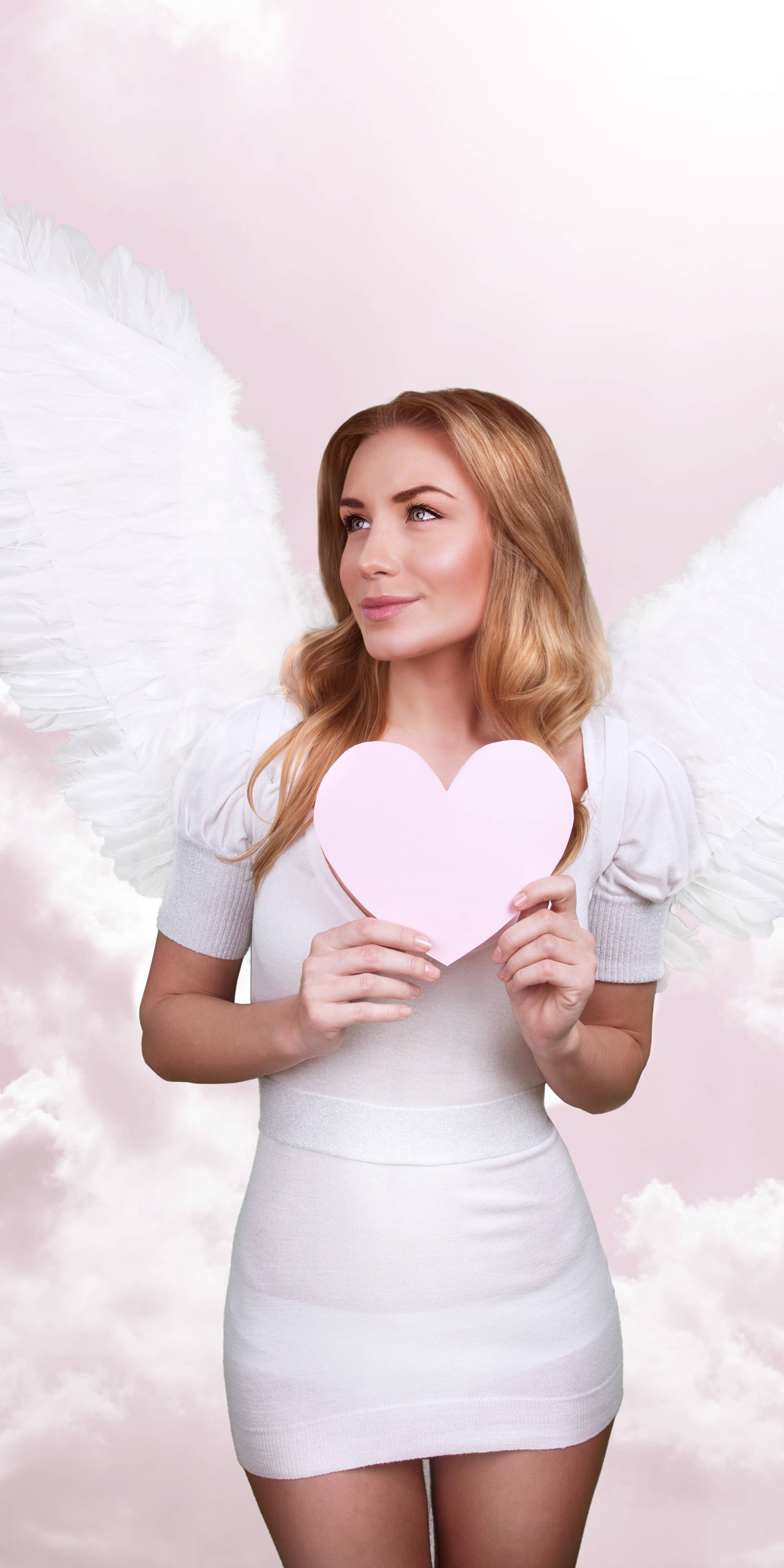 Angel of love, beautiful girl with great white feather wings in 